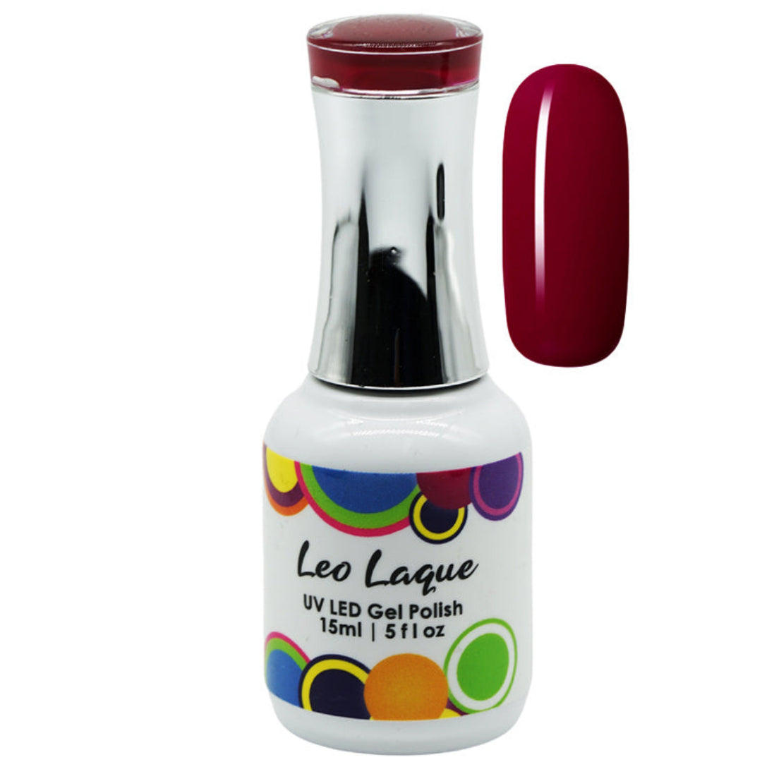 A bottle of Leo Laque UV LED Gel Polish with a white label, colorful polka dots, and a metallic silver neck, shown next to a vertical swatch of the deep burgundy red gel polish.