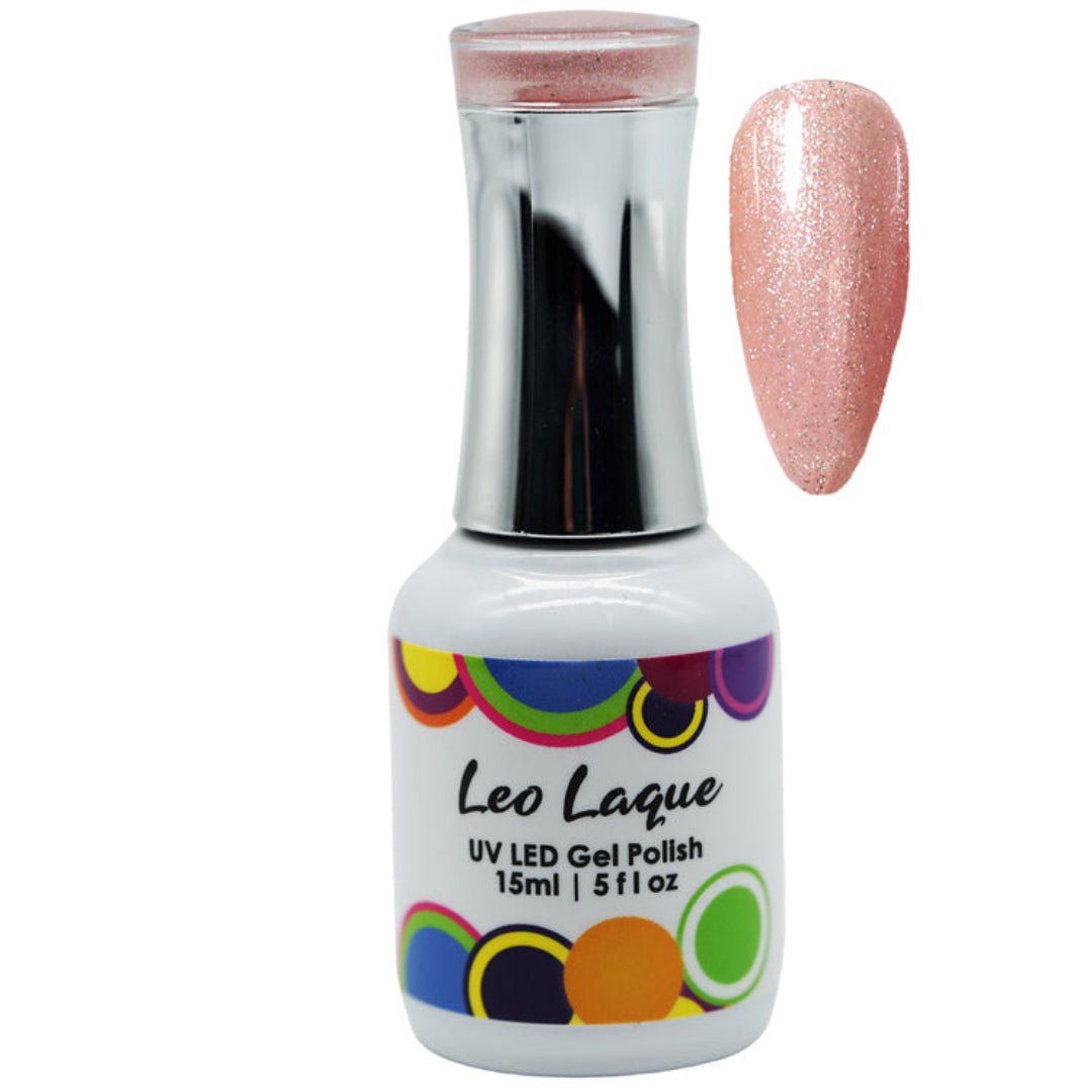 A bottle of Leo Laque UV LED gel polish with a metallic silver cap and a white label featuring colorful circular patterns. A swatch of the glittery pink polish is shown next to the bottle on a plain white background.
