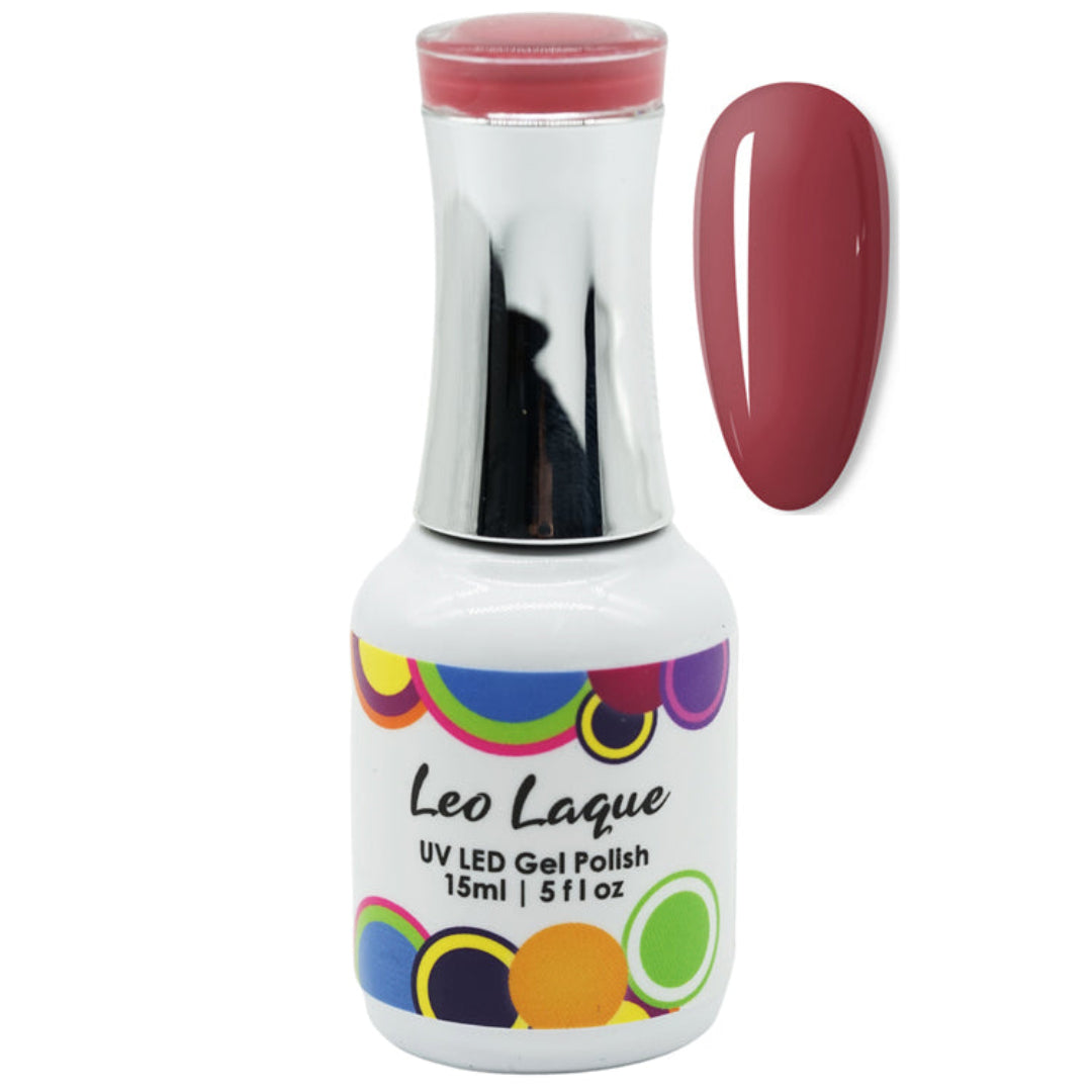 A bottle of Leo Laque UV LED Gel Polish with a white label, colorful circular accents, and a reflective silver cap, shown next to a vertical oval swatch of the deep berry-red polish color on a white background.