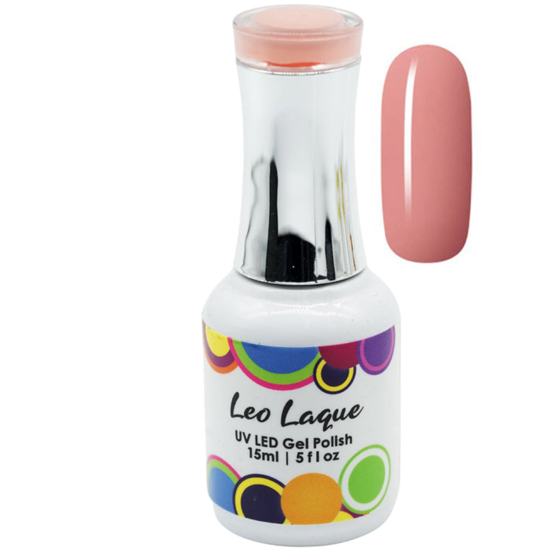 A bottle of Leo Laque UV LED gel polish with a white label and colorful polka dots, shown next to a glossy swatch of the pinkish-peach gel polish color.