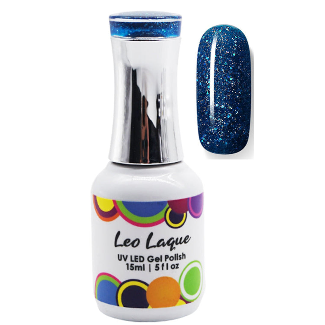 A bottle of Leo Laque UV LED gel polish with a silver cap and a white label, shown next to a nail swatch displaying a sparkling dark blue glitter polish.