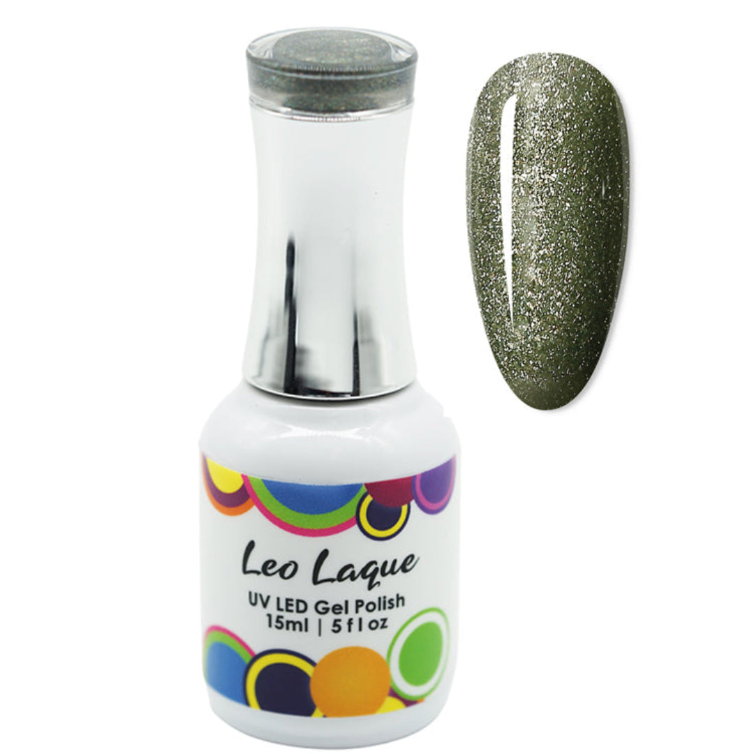 A bottle of Leo Laque UV LED gel polish with a silver cap and a white label featuring colorful circular patterns, shown next to a nail swatch displaying the olive green glitter polish color.