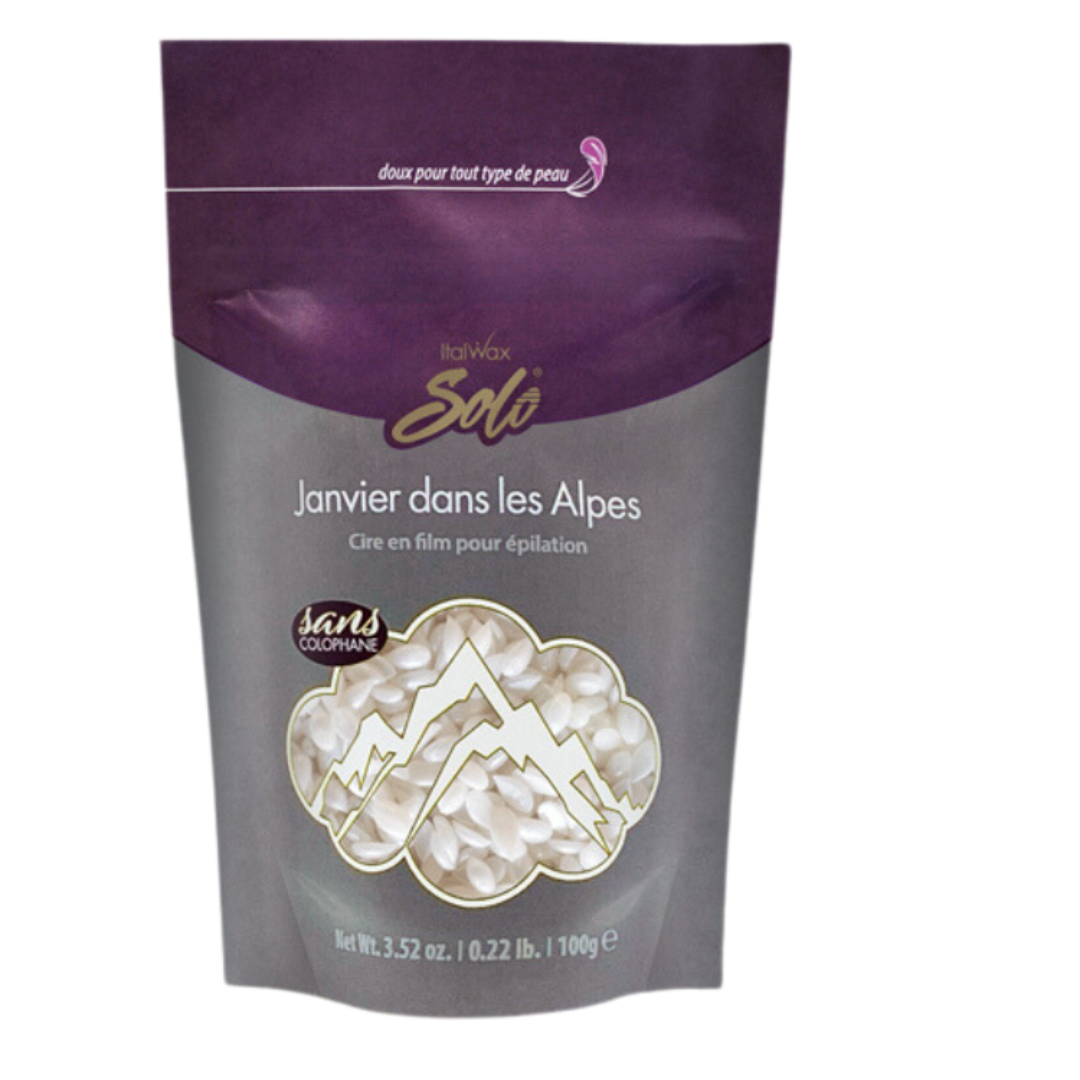 W317B Italwax 100g Synthetic Crystal Film Wax | A bag of pearl white Italwax Crystal film wax, in a grey and purple bag branded with Italwax Solo Janvier dans Les Alpes with pearl white wax beads showing through
